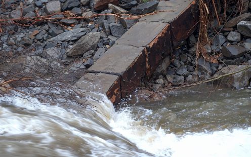 An unearthed duct bank partially submerged by flooding.