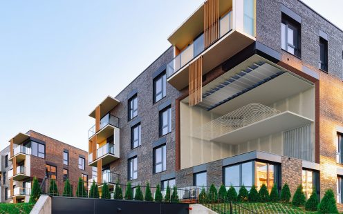 Modern residential home apartment building architecture with garage. House and parking concept.